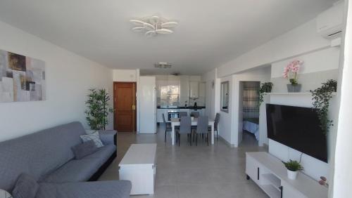 a living room with a couch and a tv at vivienda fines turisticos in Málaga