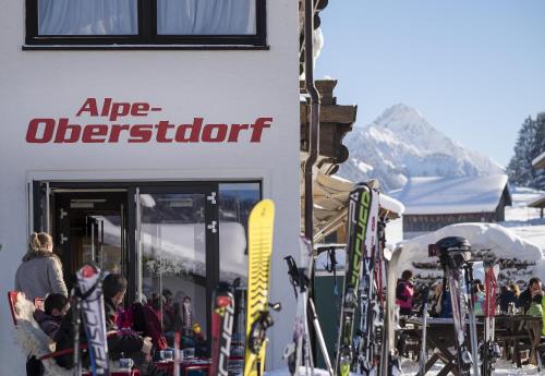 a group of skis parked outside of a ski shop at Alpe Oberstdorf in Oberstdorf