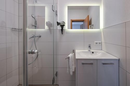 a bathroom with a shower and a sink at Pension Freiheit in Pfronten