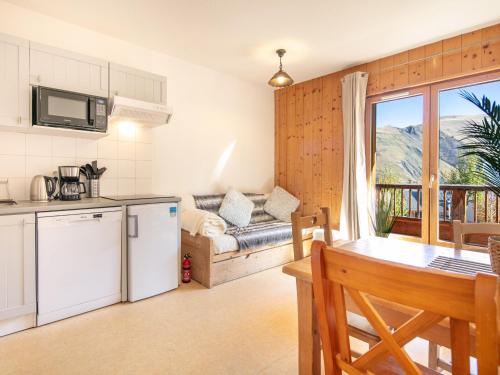 a kitchen and living room with a couch and a table at Les Bouquetins - 5 - Appart Chaleureux 6 pers in Saint-Sorlin-dʼArves