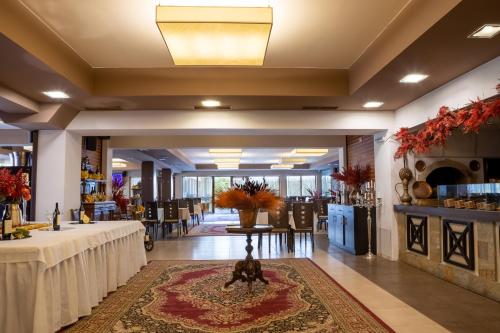 a banquet hall with a table in the middle of a room at Ostrova Holiday Village in Beli Osŭm