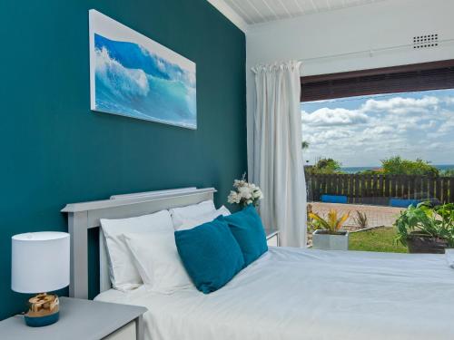 a bedroom with a bed and a large window at Sunrise Bettys Bay in Bettyʼs Bay