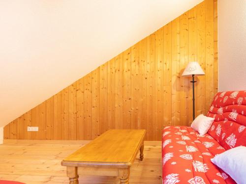 ein Wohnzimmer mit einem Sofa und einem Tisch in der Unterkunft Les Tetras - 64 - Spacieux Appart 10 pers in Saint-Sorlin-dʼArves