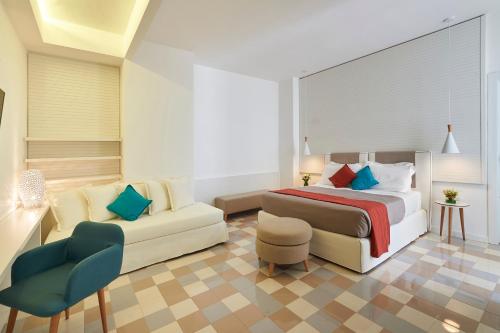 a bedroom with a bed and a couch at Grand Hotel Riviera - CDSHotels in Santa Maria al Bagno