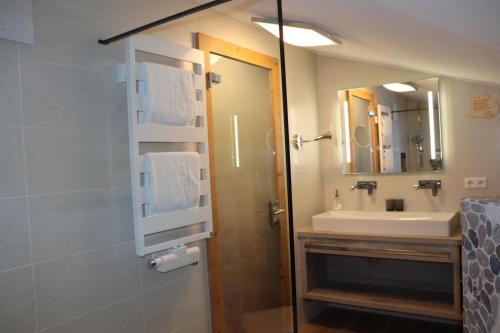 a bathroom with a sink and a mirror at Zum Eichhof Zimmer 12 in Reit im Winkl