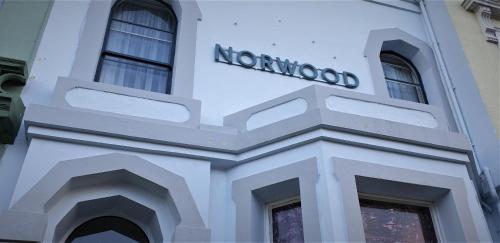 a white building with a norenomed sign on it at The Norwood in Torquay