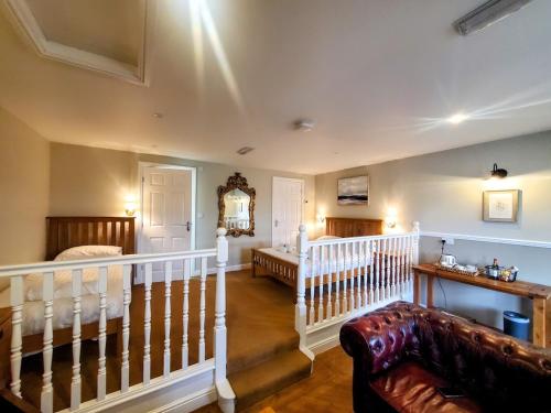 a living room with a staircase and a couch at The Golden Ball Hotel in Morecambe