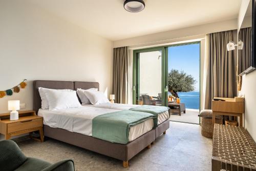 a bedroom with a bed and a view of the ocean at Joy Aqua in Skala
