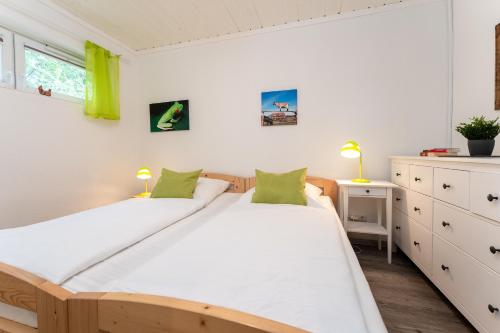 a bedroom with two beds and a desk at Blankwasserweg 131 Lensterstrand Oase Bungalow 7 in Lenste