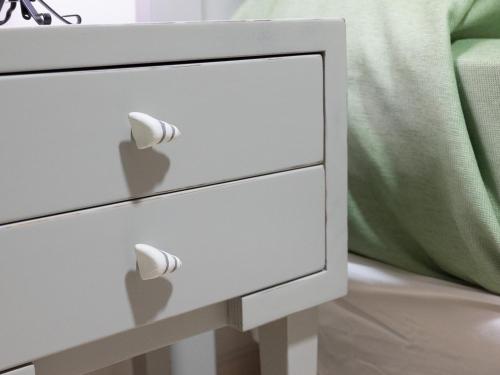 a white dresser with two drawers next to a bed at Primera Planta Punta Umbria 2 dormitorios junto al mar (1) in Punta Umbría