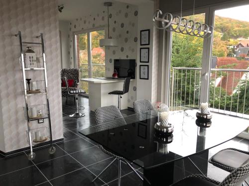 a living room with a glass table and chairs at Haus Brockenblick in Wernigerode