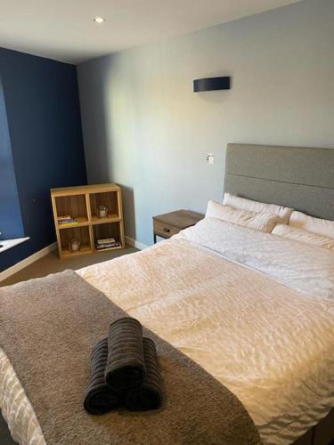 a bedroom with a bed with a pair of slippers on it at The Thisle in Bristol