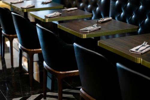 a row of tables and chairs in a restaurant at Hotel 87 eighty-seven - Maison d'Art Collection in Rome