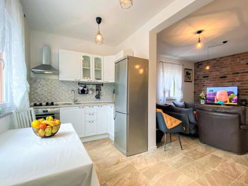 a kitchen with a table with a bowl of fruit on it at Villa Vinka in Kozica