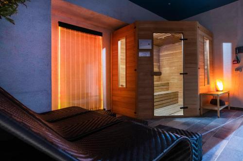 a bedroom with a bed and a glass door with a shower at Hotel 87 eighty-seven - Maison d'Art Collection in Rome