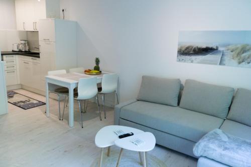 ein Wohnzimmer mit einem Sofa und einem Tisch in der Unterkunft Ferienwohnung Glücksburg 3322 in Ulstrupfeld