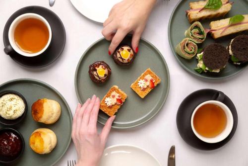 a table topped with plates of food and cups of tea at Hyatt Regency Brisbane in Brisbane
