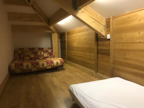 a bedroom with two beds and wooden walls at Appartement Tignes, 4 pièces, 6 personnes - FR-1-480-2 in Tignes