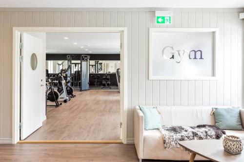 a living room with a door leading to a gym at Katrinelund Gästgiveri & Sjökrog in Stora Mellösa