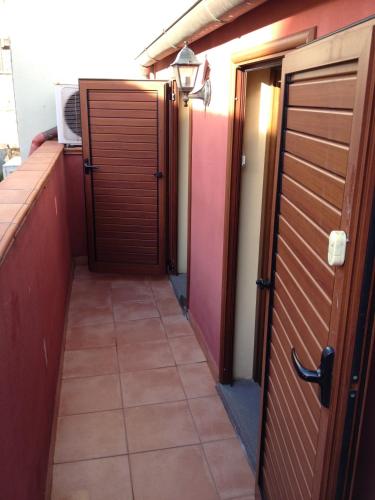 a hallway with two doors and a tiled floor at Domoruja B&B in Sassari