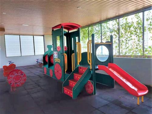 a play room with a slide and a playground at Spacious 1BR Kingbed Seaview Pool Wifi 8min Jonker Atlantis in Tranquerah
