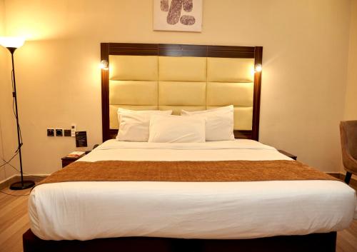 a bedroom with a large bed in a hotel room at MayFair Hotel Maitama Abuja in Abuja