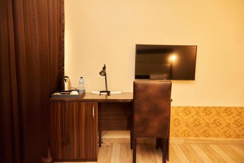 a desk with a chair in a room at MayFair Hotel Maitama Abuja in Abuja
