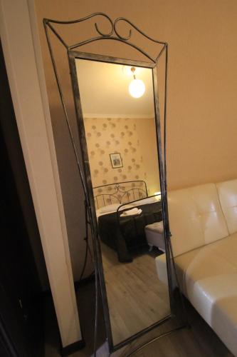 a mirror in front of a room with a bed at Hotel Svaneti in Mestia