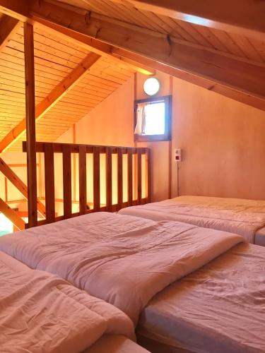 two beds in a room with a attic at Camping Gran Sol in Montferrer