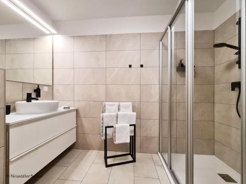 a bathroom with a sink and a shower at St. Antoni Suite 5 in Eisenstadt