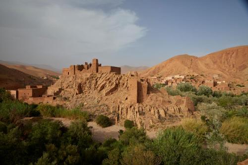 a village on top of a mountain in the desert at Kasbah Flilou in Aït Ougliff