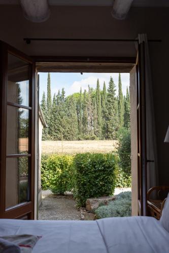 a bedroom with a door open to a garden at Domaine Gaogaia in Aix-en-Provence