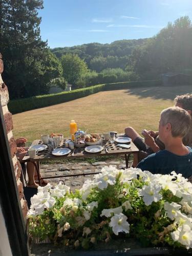 a young boy sitting at a table with food at Chambre d hôtes Le Joyau with indoor pool and sauna in Lasne