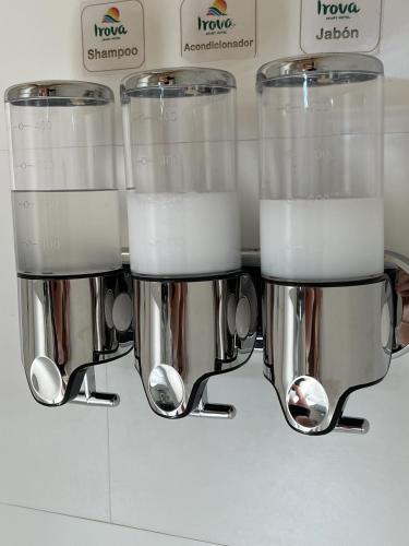 a group of three juicer cups on a counter at Irová Apart Hotel in Posadas