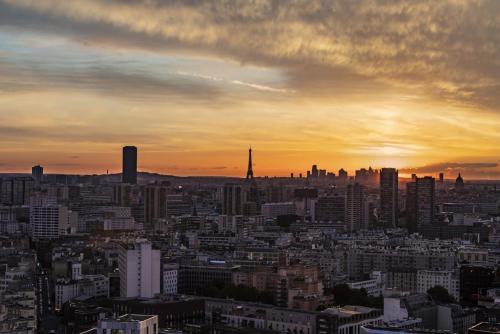a view of a city skyline at sunset at Too Hotel & Spa Paris - MGallery Collection in Paris