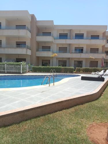 a swimming pool in front of a building at Marina Bahia in Saïdia