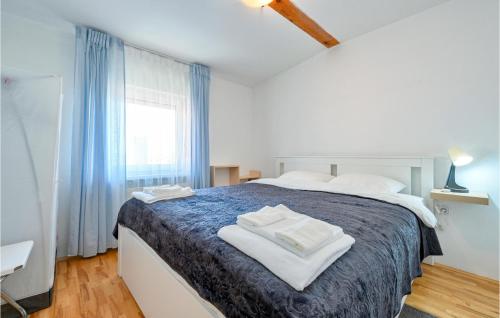 a bedroom with a large bed with towels on it at Cozy Home In Okrugli Vrh With Kitchen in Okrugli Vrh