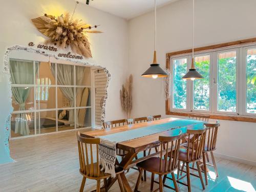 a dining room with a blue table and chairs at Chon's Dock Homestay & House Lease in Phan Thiet