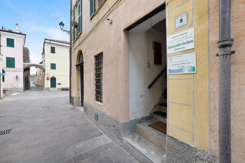 a building with a door open on a street at Ultimo Tiro-appartamento Terzo Tiro in Cisano sul Neva