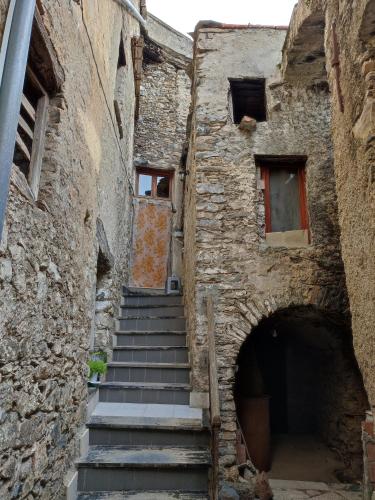 a set of stairs in an old stone building at Agriturismo Nonnamelia in Nasino
