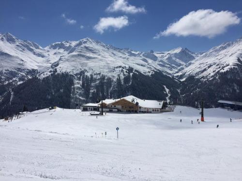 a ski lodge on top of a snow covered mountain at Haus Timmler in Sankt Anton am Arlberg