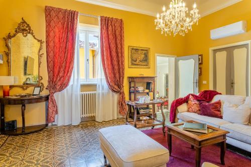 a living room with a couch and a chandelier at Villa De Maestri in Lucca