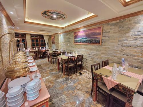 a restaurant with tables and chairs and plates on display at Sherpa Home Hotel in Kathmandu