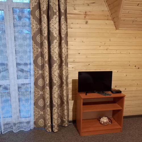 a room with a desk with a television and a window at Dream House in Yablunytsya