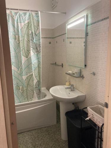une salle de bain avec un lavabo et un rideau de douche dans l'établissement Beau meublé 3 pièces 60 m² Cannes Le Suquet, à Cannes