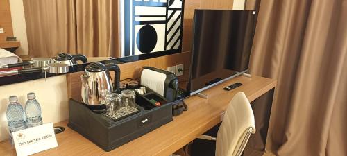 a room with a desk with a phone and water bottles at Astoria Hotel & SPA in Hunedoara
