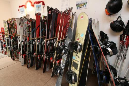 a bunch of skis and snowboards are lined up against a wall at Saint George Palace Aparthotel in Bansko