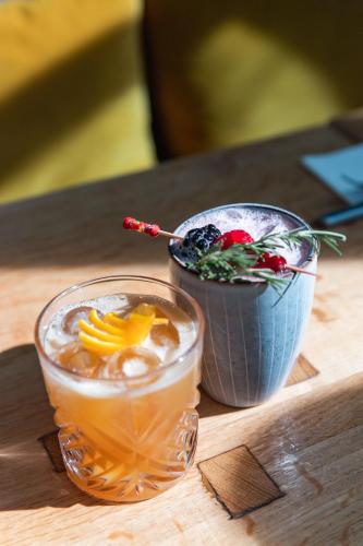 a wooden table with a drink and a bowl of fruit at Domaine Gaogaia in Aix-en-Provence