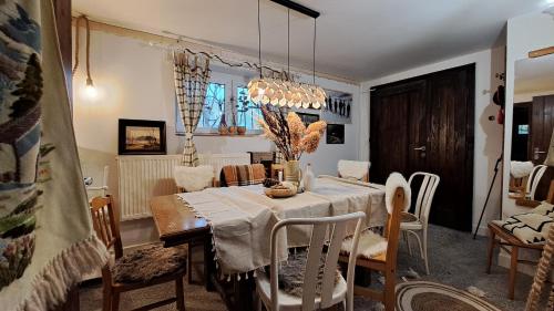 a dining room with a table and chairs at Na stoku in Korbielów