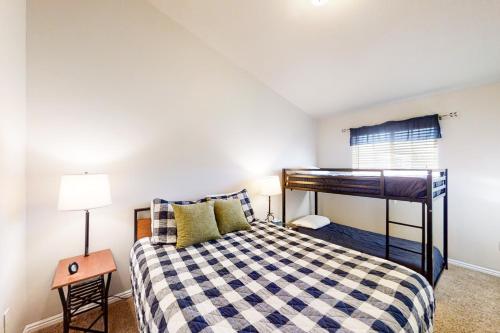 a bedroom with a bunk bed and a table at Kokomo Kottage in Garden City